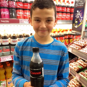 He was so excited to see a coke bottle with his brother's name on it.  